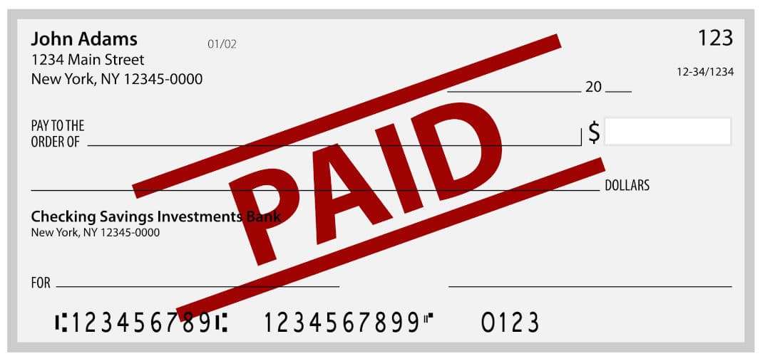 A (blank) cheque stamped paid.